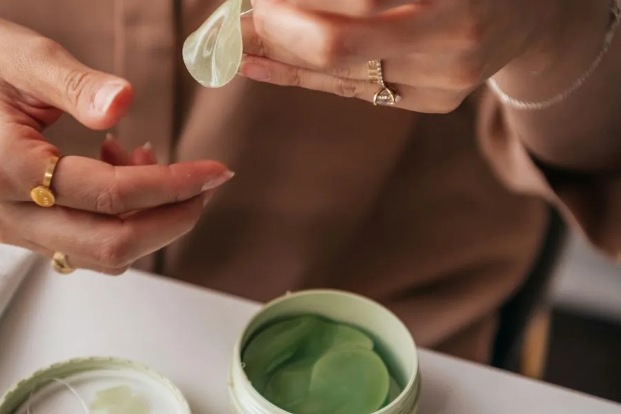 woman's hands handling cosmetic eye masks